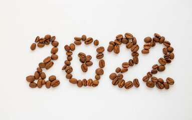 The numbers 2022 on a white background are laid out from coffee beans. On New Year's Eve 2022.New calendar year