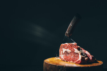 butcher knife and meat on a cutting board - 416341955