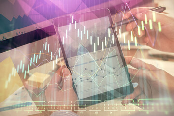 Double exposure of man's hands holding and using a phone and financial chart drawing. Market analysis concept.