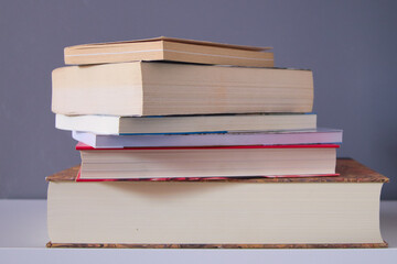 group of reading books on grey background on the white table