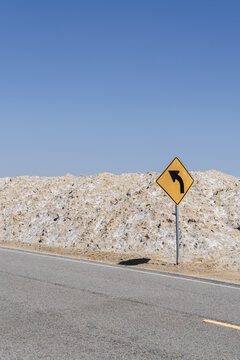 Caution Curve Ahead Sign On A Lonely Desolate Road In The Desert. 