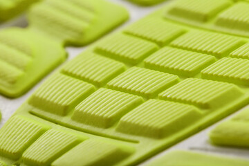 Close-up of the tread of a yellow sneaker, the textured pattern of the sole.