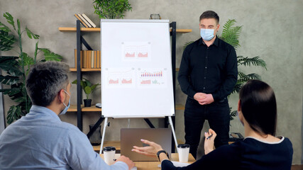 Top manager company offline online presenting financial report diagram on flip chart listen business owner. Man and woman in protective medical face mask, social distancing post coronavirus pandemic