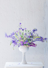 summer bouquet in blue and violet colors on white background