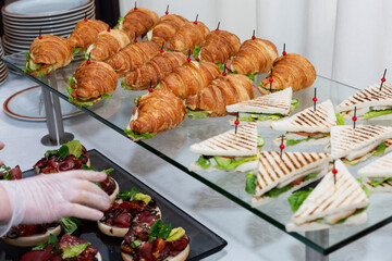 Croissant sandwich on the buffet table. Catering for business meetings, events and celebrations. Close-up.