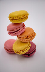 A vertical stack of red and yellow macarons