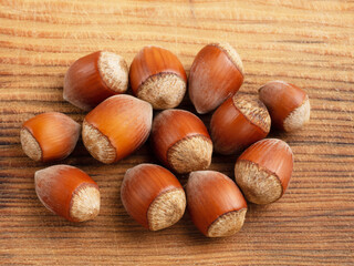 Handful of hazelnuts on brown wooden background