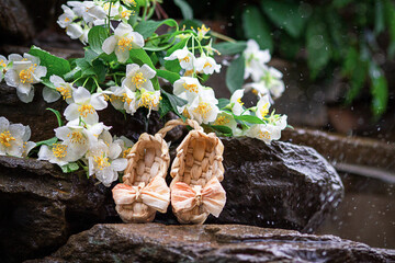 Jasmine, a bouquet of Jasmine lying on a rock at the waterfall. Flowers in the rain. Selective focus.