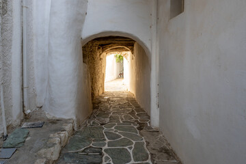 Narrow street in Castro (Kastro), the oldest part of the Chora town on Folegandros island. Cyclades, Greece