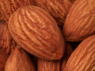 Almond in a bowl on wooden background with copy space