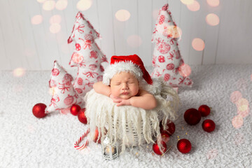 Obraz na płótnie Canvas first photo session. newborn child. child in in a New Year's image. first pictures of newborn new year