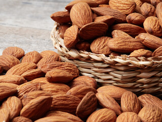 Almond in a bowl on wooden background with copy space