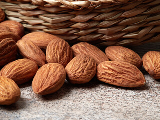 Almond in a bowl on wooden background with copy space