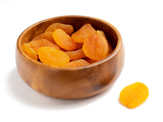 Dried apricots in wooden bowl on white