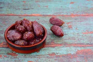 Organic Medjool dates on green wooden background