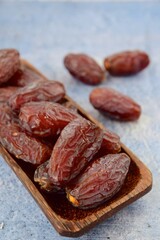 Fresh raw organic Medjool dates on blue background, selective focus