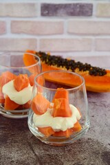 Cubed papaya and yogurt in glass sprinkle with bee pollen