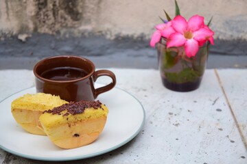 Kue Pukis, Traditional Javanese half-moon shaped pancakes. made from flour, eggs, yeast and coconut milk. Served with cup of tea