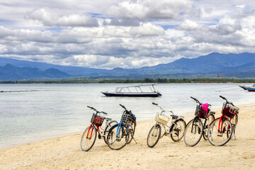 Fototapeta premium Low tide Island Indonesia. Gili Air 03.01.2017. View of Lombok Island. The main means of transportation on the island, a bicycle.