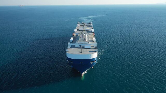 Aerial drone video of huge car carrier ship RO-RO (Roll on Roll off) cruising in Mediterranean deep blue ocean sea