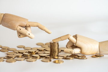 Business Money, Saving and Planning Concept. Closeup of wooden hand pointing to stack of gold coins...