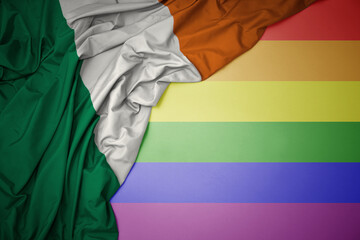 waving national flag of ireland on a gay rainbow flag background.