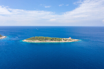 Fototapeta na wymiar Aerial drone shot of Host Island in Adriatic sea near town port of Vis Island in Croatia summer