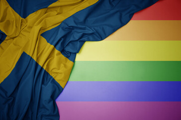 waving national flag of sweden on a gay rainbow flag background.