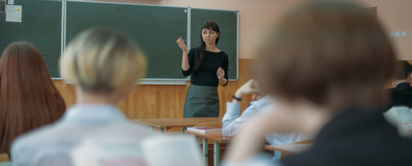 The teacher is teaching a lesson at school.