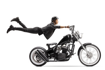 Fototapeta na wymiar Young male biker riding a chopper and flying