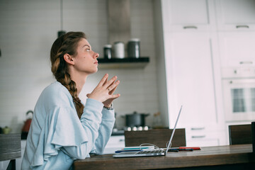 Woman works with laptop at home in the living room