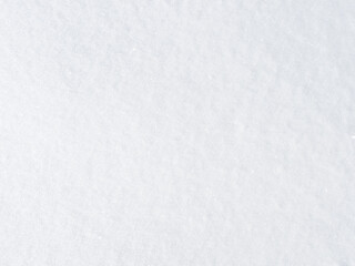 background of fresh snow texture in bright white, sparkling in the sun