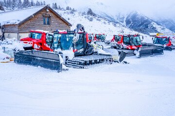AURON, FRANCE - 02.01.2021: Snow plow trucks under the snow on a parking in the ski resort...
