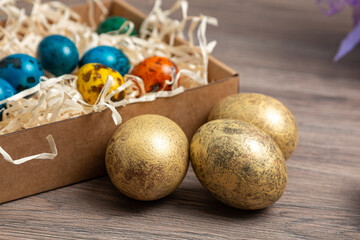 Golden Easter eggs on the kitchen table. Preparing for Easter