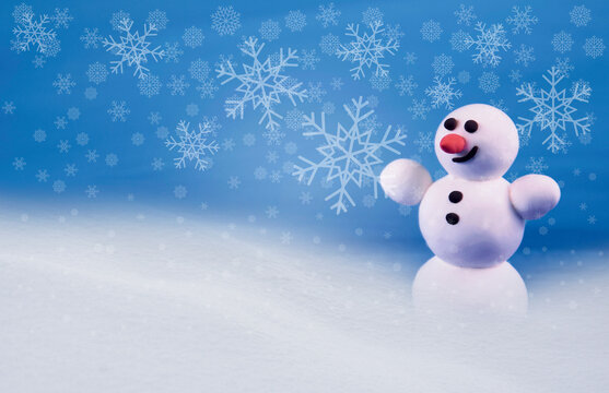 Cute snowman in a snowy landscape stock images. Winter landscape with snowman images. Happy snowman in winter scenery. Holiday blue snowy background with snowman
