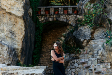 Girl in black dress and glasses posing 