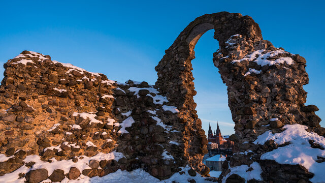 Stone ruins of an ancient medieval Rezekne castle in Latgale, Latvia. Arch on background of blue sky. Catholic Church.