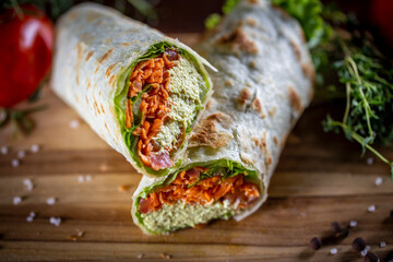 Vegetarian wrap sandwich on wooden background