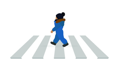 A small child in a hat and warm overalls walks along a pedestrian crossing on a white background