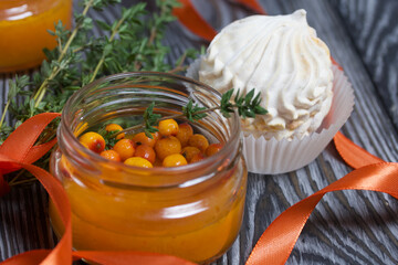 Sea buckthorn jelly. Decorated with sea buckthorn berries and thyme. Nearby is sea buckthorn marshmallow.