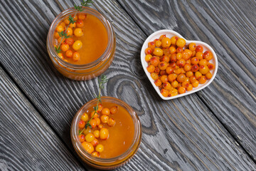 Sea buckthorn jelly. Decorated with sea buckthorn berries and thyme.