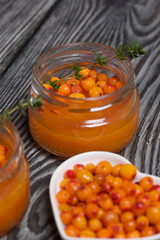 Sea buckthorn jelly. Decorated with sea buckthorn berries and thyme. Nearby is sea buckthorn marshmallow.
