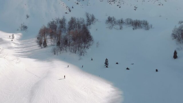 Backcountry Skiing - Skiers Skiing On Snowy Downhill Of Planina Suha During Sunny Winter Day In Rodica, Slovenia. - aerial