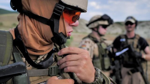 Airsoft. Soldier talks the walkie-talkie. Ready to the military operation