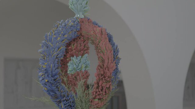 Self-made colorful palm stick, placed next to an ambo in a church