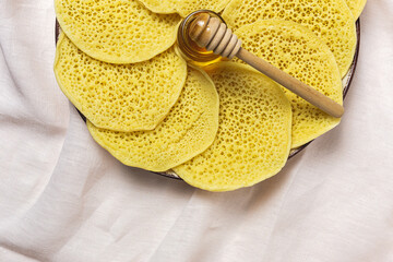 Homemade traditional moroccan baghrir with honey, strawberries and mint from above