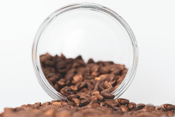 Turkish coffee beans pouring from jar isolated on white background. Side view of many coffee beans which is very popular in Middle East.