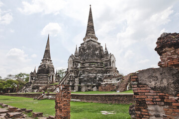 Fototapeta premium AYUTTHAYA, THAILAND - MAY 25, 2018: Ayutthaya Historical Park in Ayutthaya (second capital of the Siamese Kingdom). A very popular destination for day trips from Bangkok. Wat Phrasisanpetch Temple. 