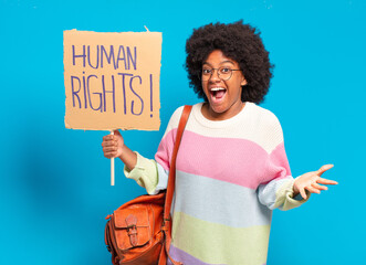 young pretty afro woman protesting with human rights banner
