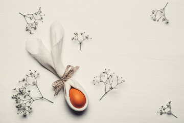 Easter background with Easter Egg with Bunny ears from linen napkin. Happy Easter concept.